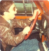 Photo of Nick Sapharas behind a car.
