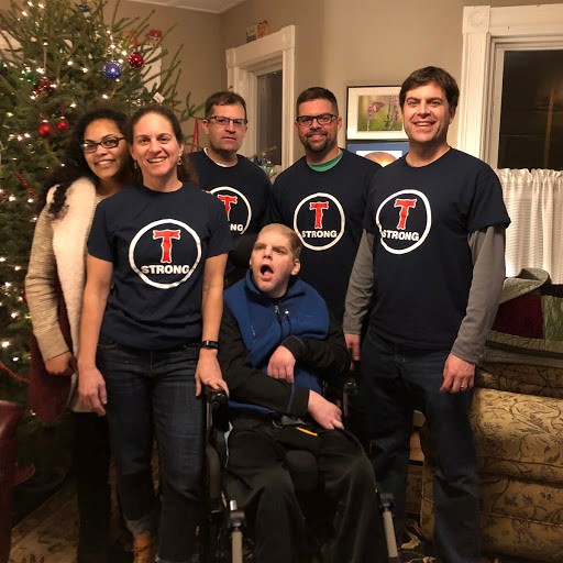 Photo of Rossetti family in front of a Christmas tree