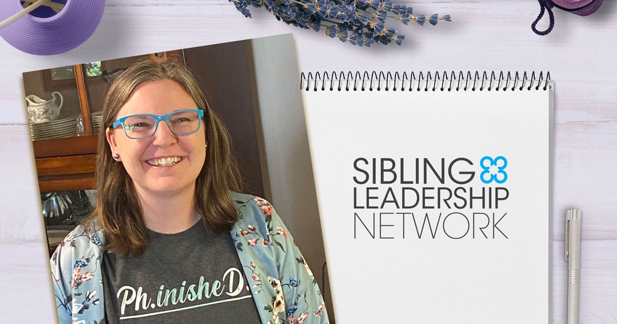 Photo of Katie Arnold, SLN Executive Director, with a t-shirt that reads “Ph.inished.D indicating that she finished her Ph.D.